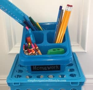 Homework supplies in a plastic bin